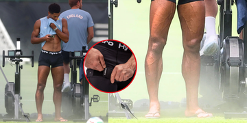 man in training gear next to exercise bikes, adjusting compression shorts.
