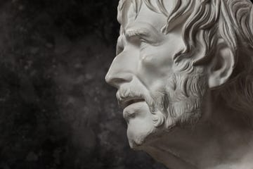 gypsum copy of ancient statue seneca head on dark textured background. plaster sculpture man face.