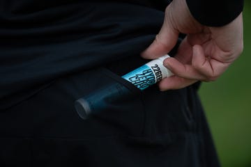 a hand retrieving a product from a pocket
