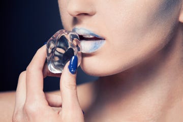 beautiful woman with cold make up, holding an ice cube