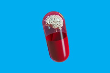 capsule containing a brain inside a red liquid