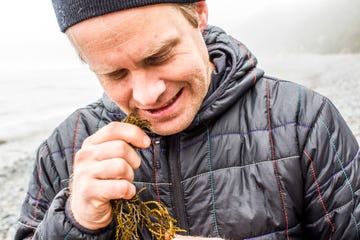 caucasian man biting seaweed near ocean
