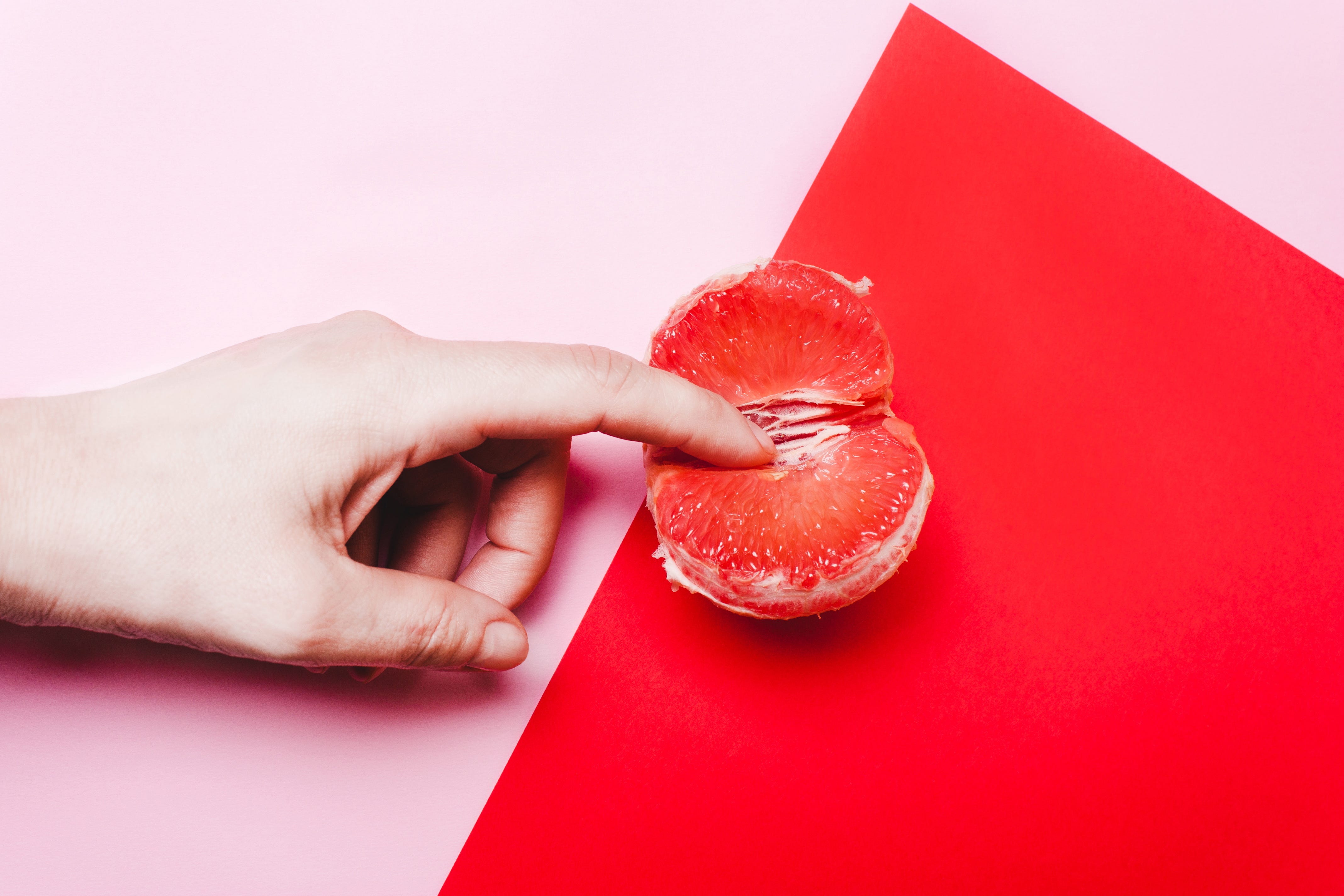 finger touching a clementine