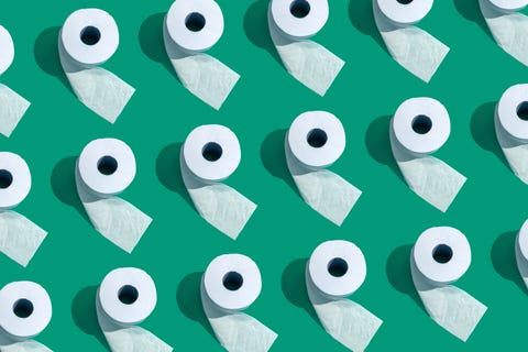many toilet rolls on green background