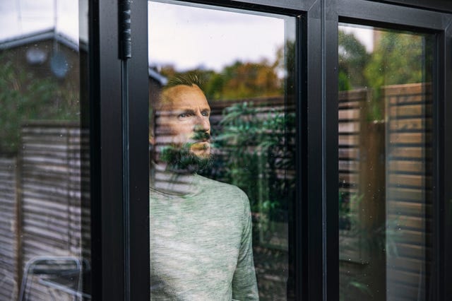 man looking through window