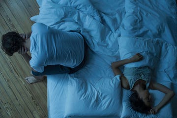 man unable to sleep while wife sleeps comfortably unaware