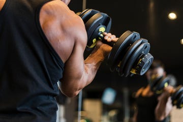 Mature adult man working out at Personal training gym