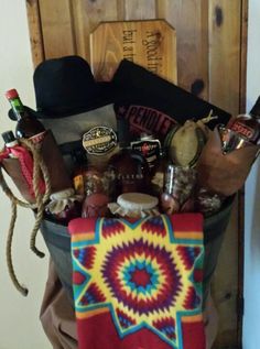 a bucket filled with assorted items sitting on top of a table