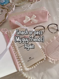 a pair of glasses sitting on top of a table next to a pink bag and some pearls
