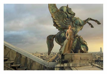 statue of a winged horse with a figure in flowing attire on a rooftop statue of a winged horse with a figure in flowing attire on a rooftop