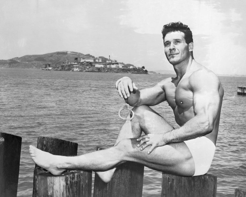 Jack LaLanne Sitting on Post Near Water jack lalanne sitting on post near water