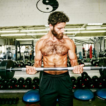 Mixed Race man lifting barbell in gymnasium mixed race man lifting barbell in gymnasium