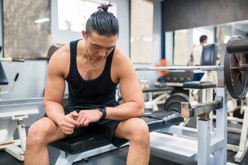 Body builder checking his vitals on a smartwatch body builder checking his vitals on a smartwatch