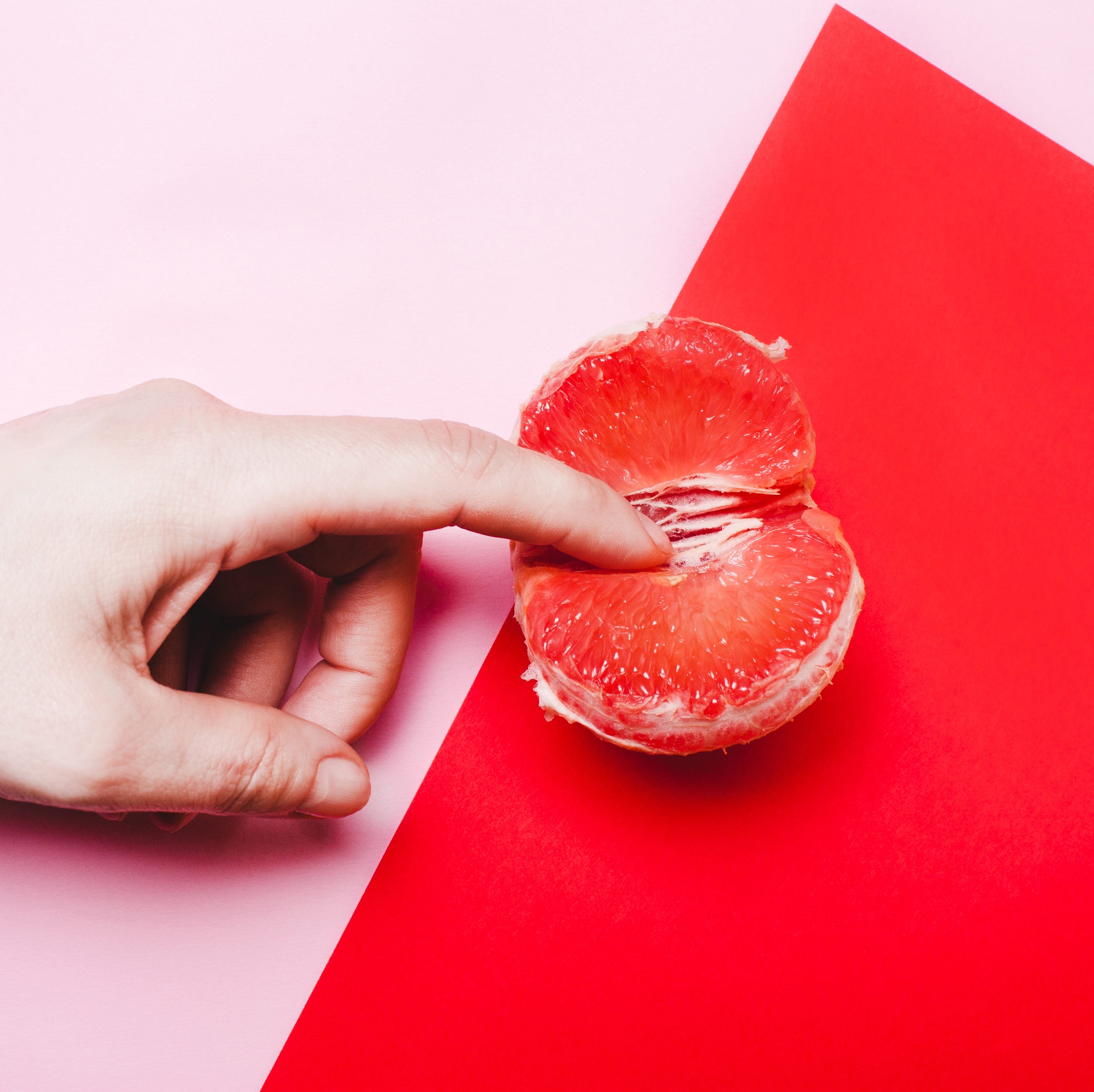 Finger touching a clementine finger touching a clementine