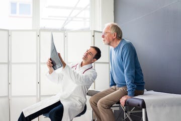 Doctor discussing MRT image with patient in medical practice doctor discussing mrt image with patient in medical practice