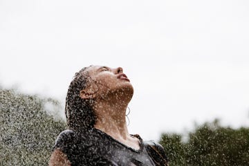 Beautiful young woman enjoying sprinkler spray on face beautiful young woman enjoying sprinkler spray on face