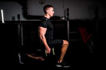 Man doing lunge with weights in the gym man doing lunge with weights in the gym