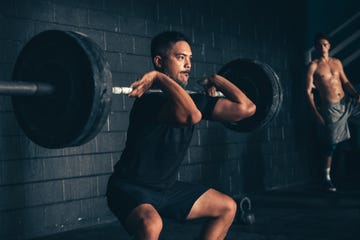 Man lifting barbell in gym man lifting barbell in gym