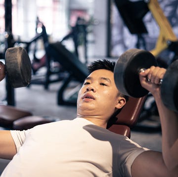 Man lifting dumbbells in the gym man lifting dumbbells in the gym