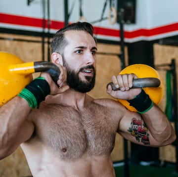 Man lifting kettlebells in gym man lifting kettlebells in gym
