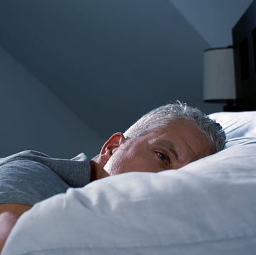 Man lying awake in bed Man lying awake in bed