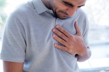 Man touching his chest in pain man touching his chest in pain