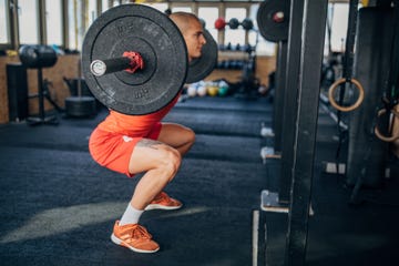 Man training on with weights in gym man training on with weights in gym