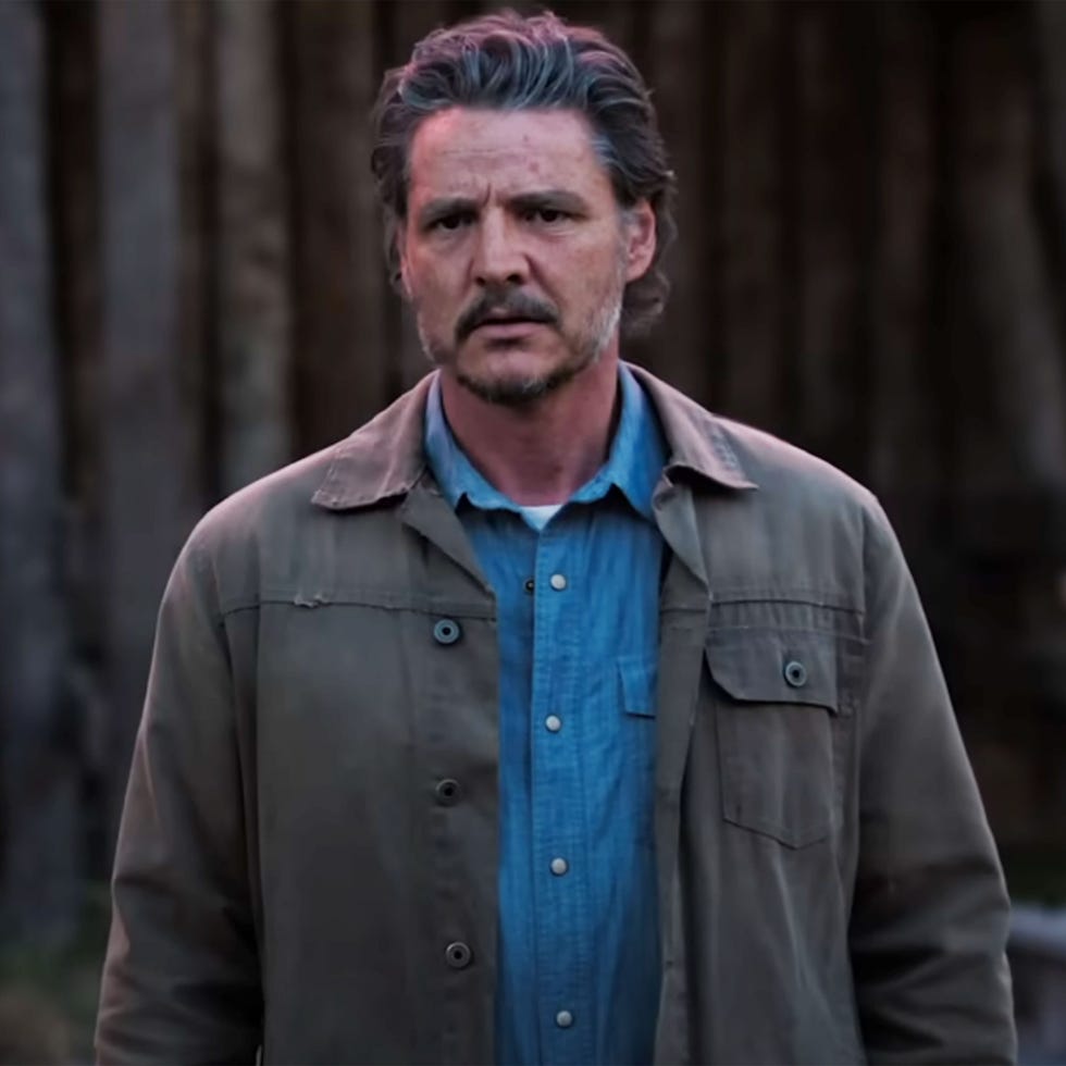 a man standing in front of trees wearing a casual outfit a man standing in front of trees wearing a casual outfit