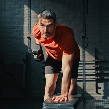 Shot of a handsome mature man using dumbbells during his workout in the gym shot of a handsome mature man using dumbbells during his workout in the gym