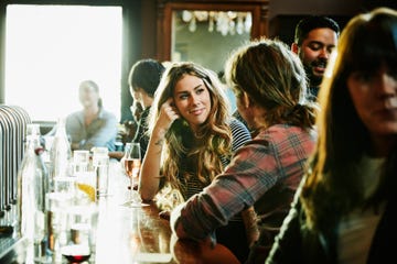 Smiling woman flirting with man while sitting in bar Smiling woman flirting with man while sitting in bar