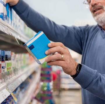 Unrecognizable mature man reads medication instructions at pharmacy unrecognizable mature man reads medication instructions at pharmacy