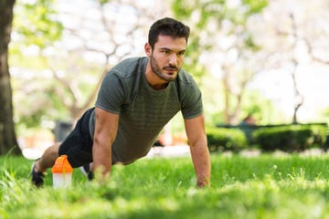 Young man doing push-up exercises in the park young man doing push up exercises in the park